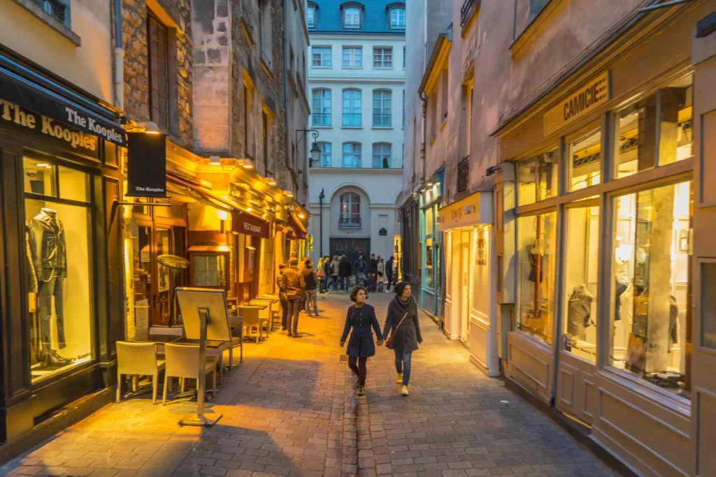 a narrow, charming, cobbled street in the marais district in Paris