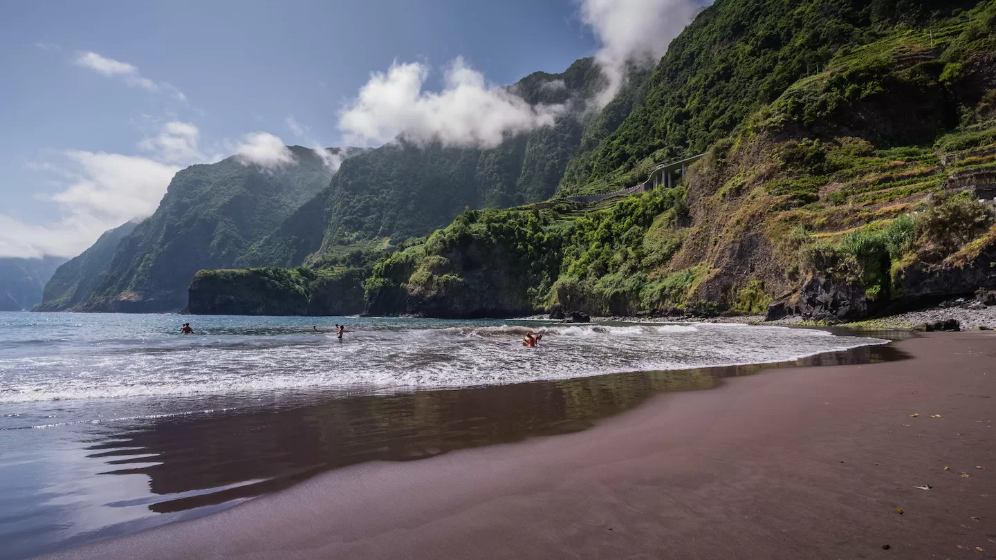 the black volcanic sand beach of seixal on the northern coast of madeira