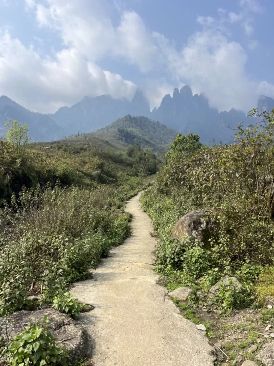 hiking trail with 4 mountain peaks rising up in the background