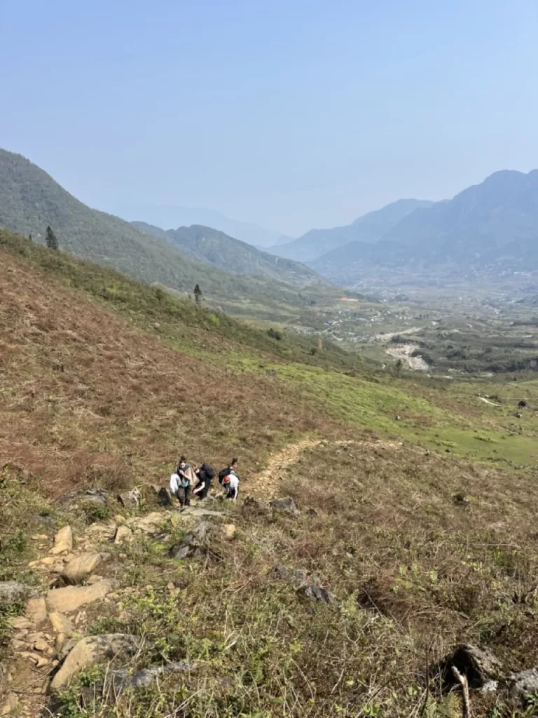 hikers walking along a slightly steep mountain trail