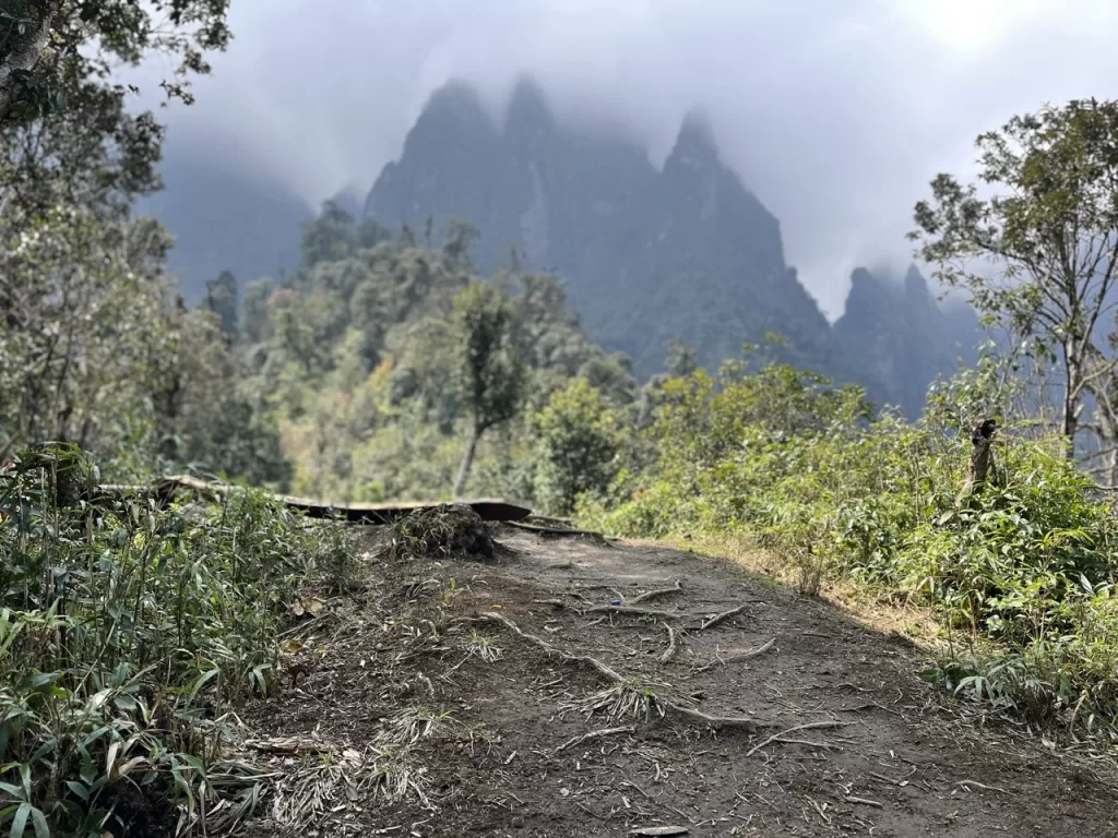 hiking trail with 4 mountain peaks rising up in the background