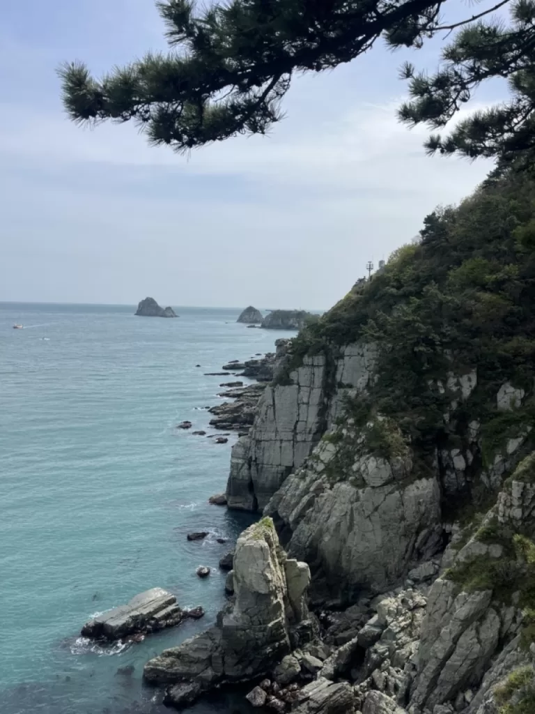 white cliffs descending into a calm light blue sea on a sunny day.