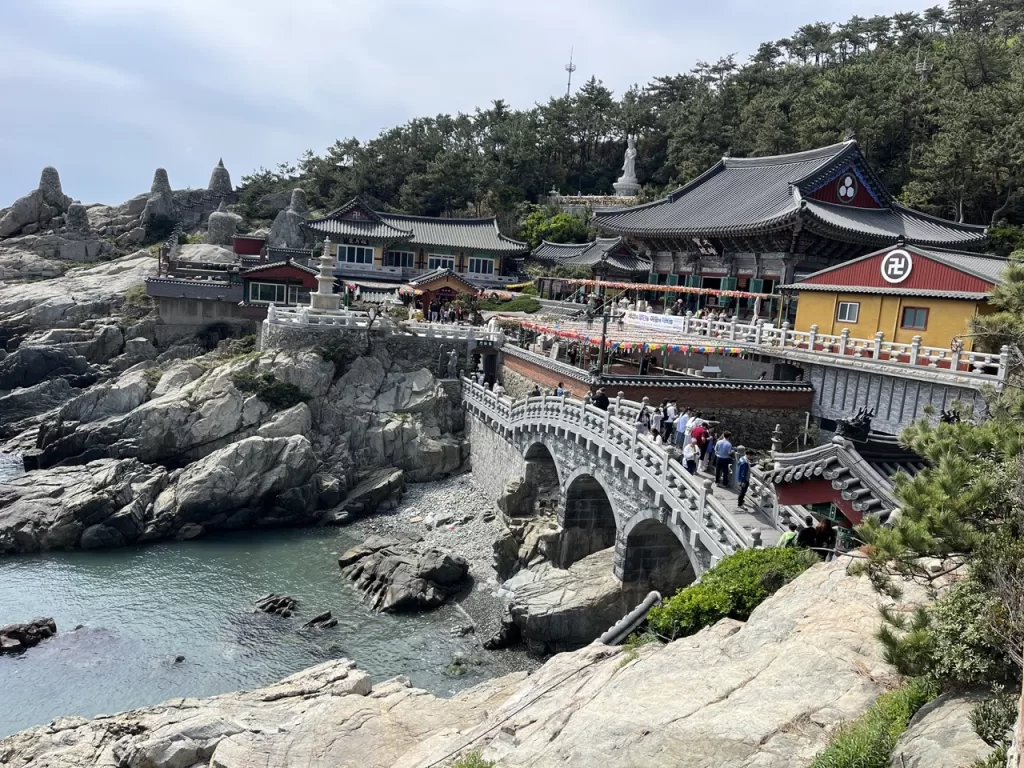 large korean buddhist temple complex on the coast, with the rocks and sea underneath