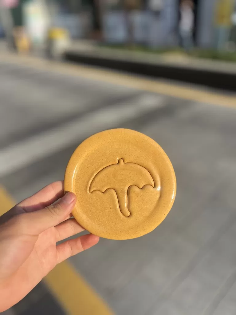 cookie with an umbrella shape from the squid game show at a market in Busan