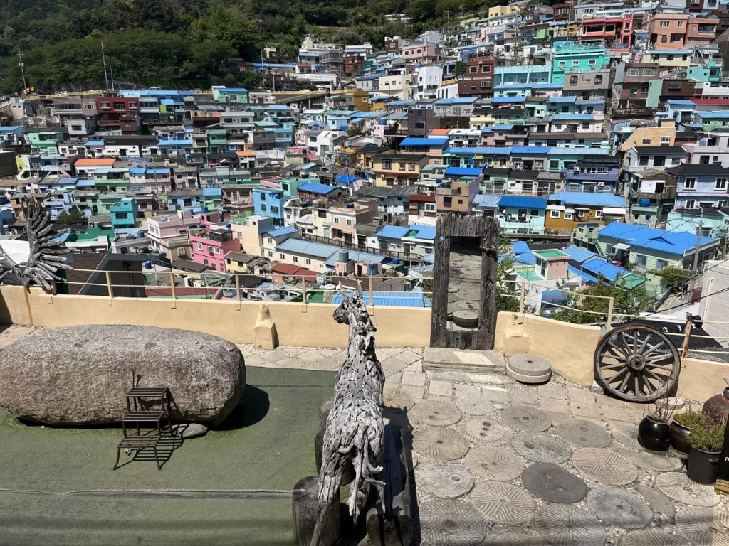a village on a steep hillside filled with small brightly colored homes