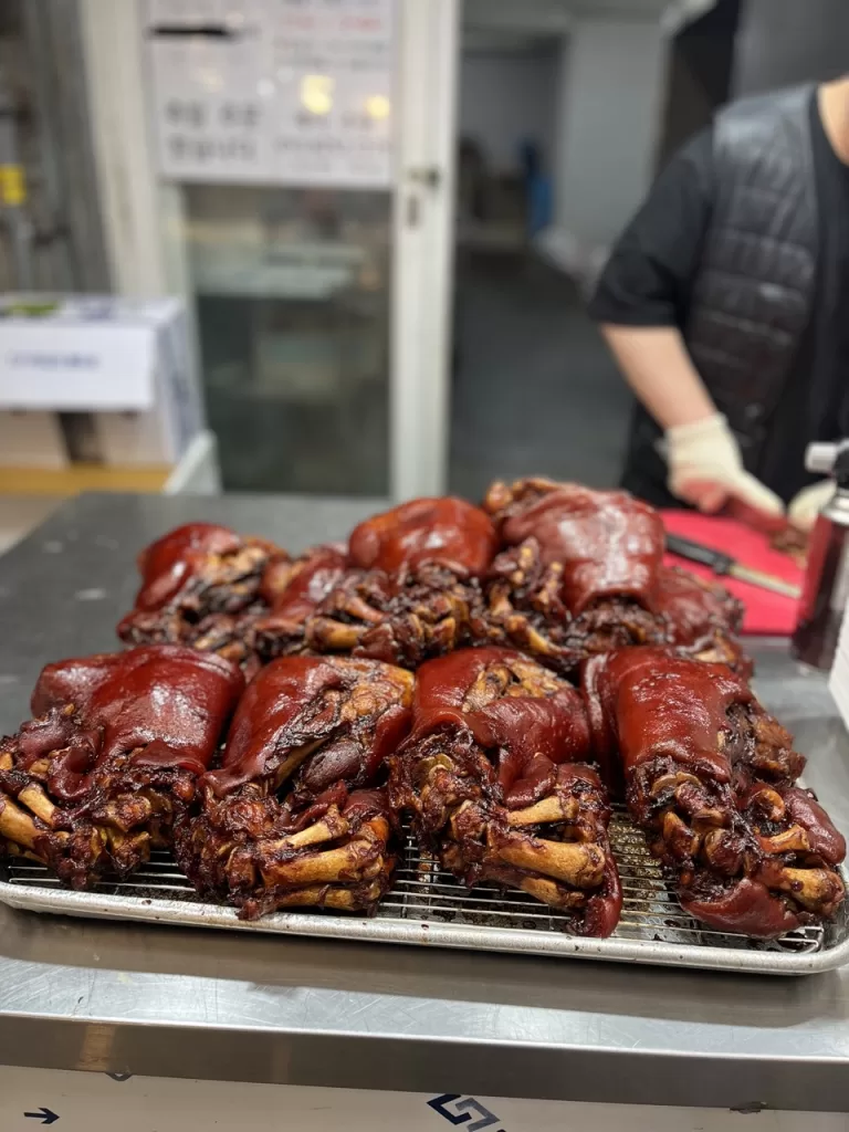 roasted pigs feet on a tray at namhang market in Busan