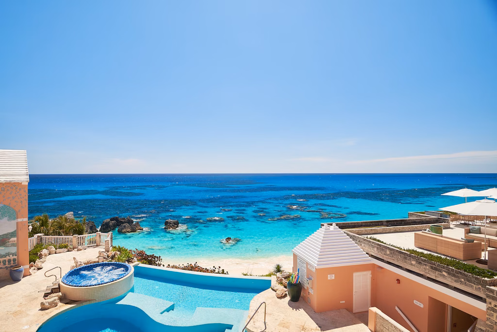 pool and hot tub above the pink sand beach and turquoise water at the reefs resort and club, bermuda