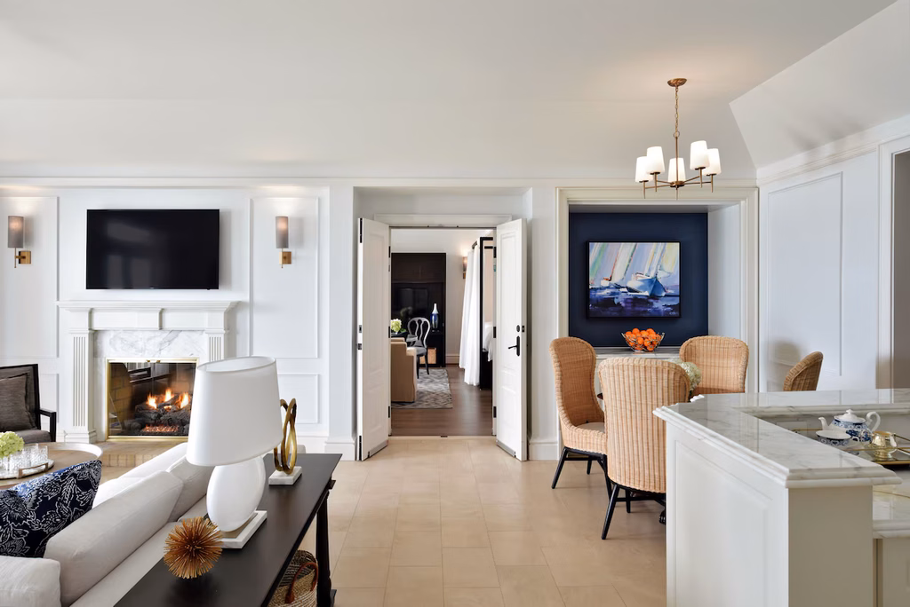 bright living room with a fireplace and open kitchen in a suite at rosewood bermuda